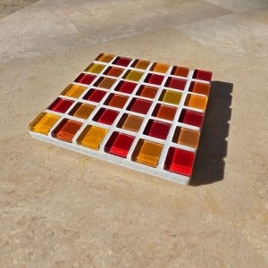 Fire coaster, red, orange and amber glass tiles on travertine