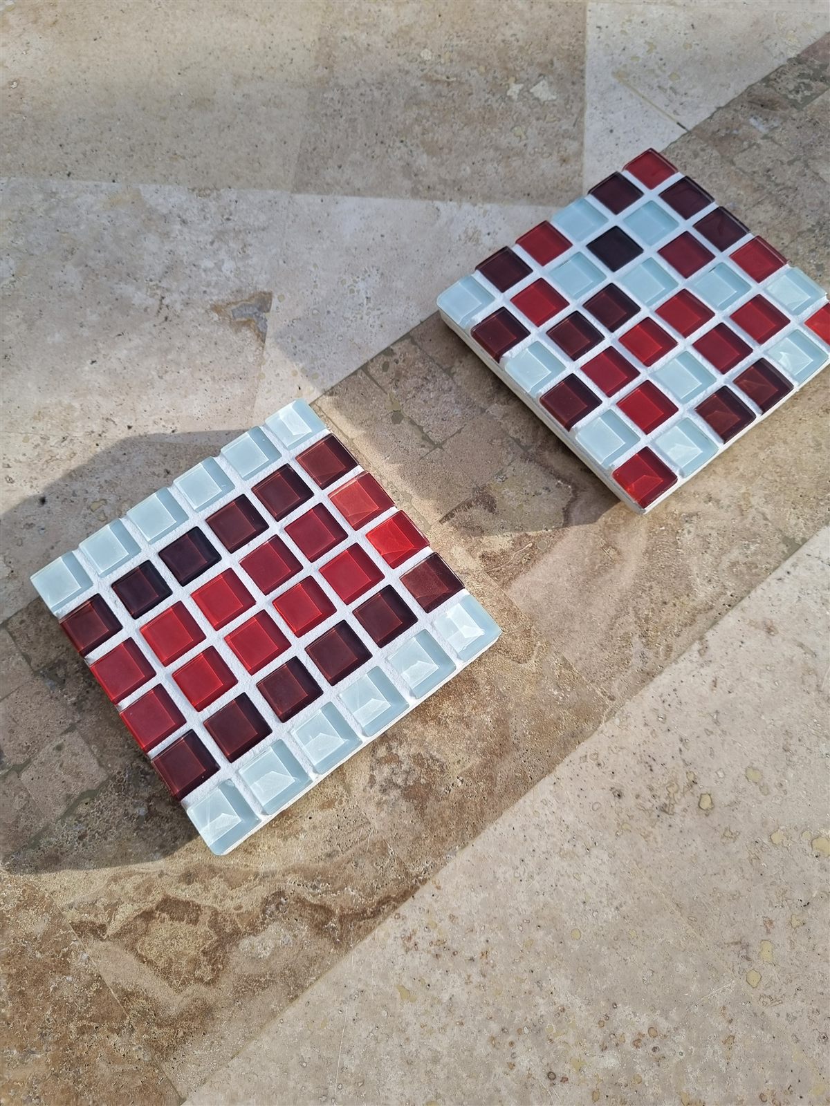 Lamington coaster, white and raspberry red glass tiles in the sun, with the Lamington Smash colourway behind