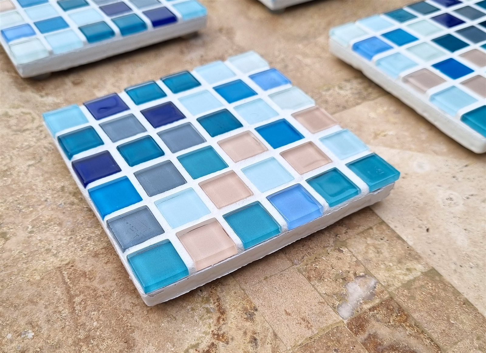 Santorini coaster, sea blues and warm cream glass tiles, close up