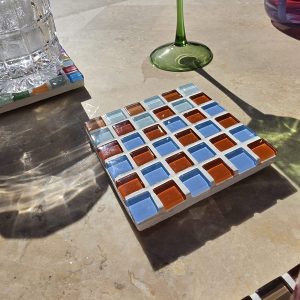 Shrimp coaster, blue, orange and warm glass tiles on travertine