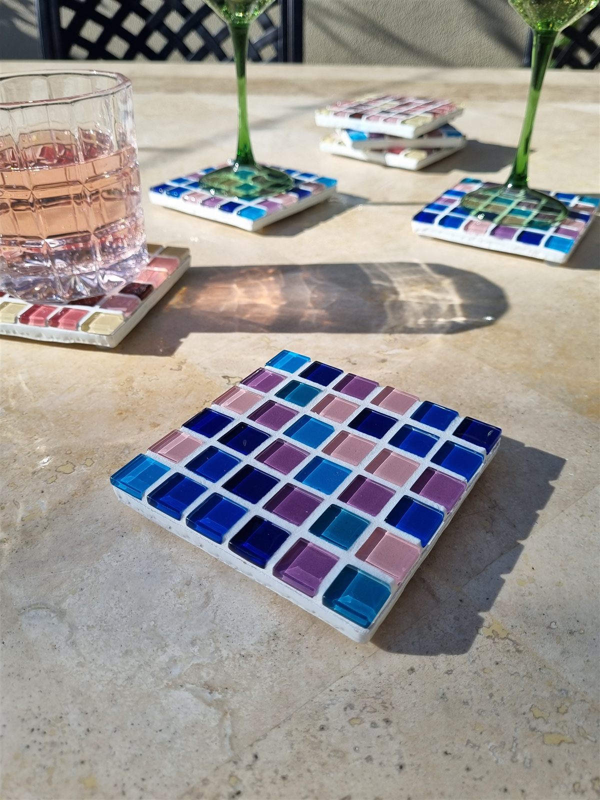 Winter Solstice coaster, deep blues and violet glass tiles on travertine
