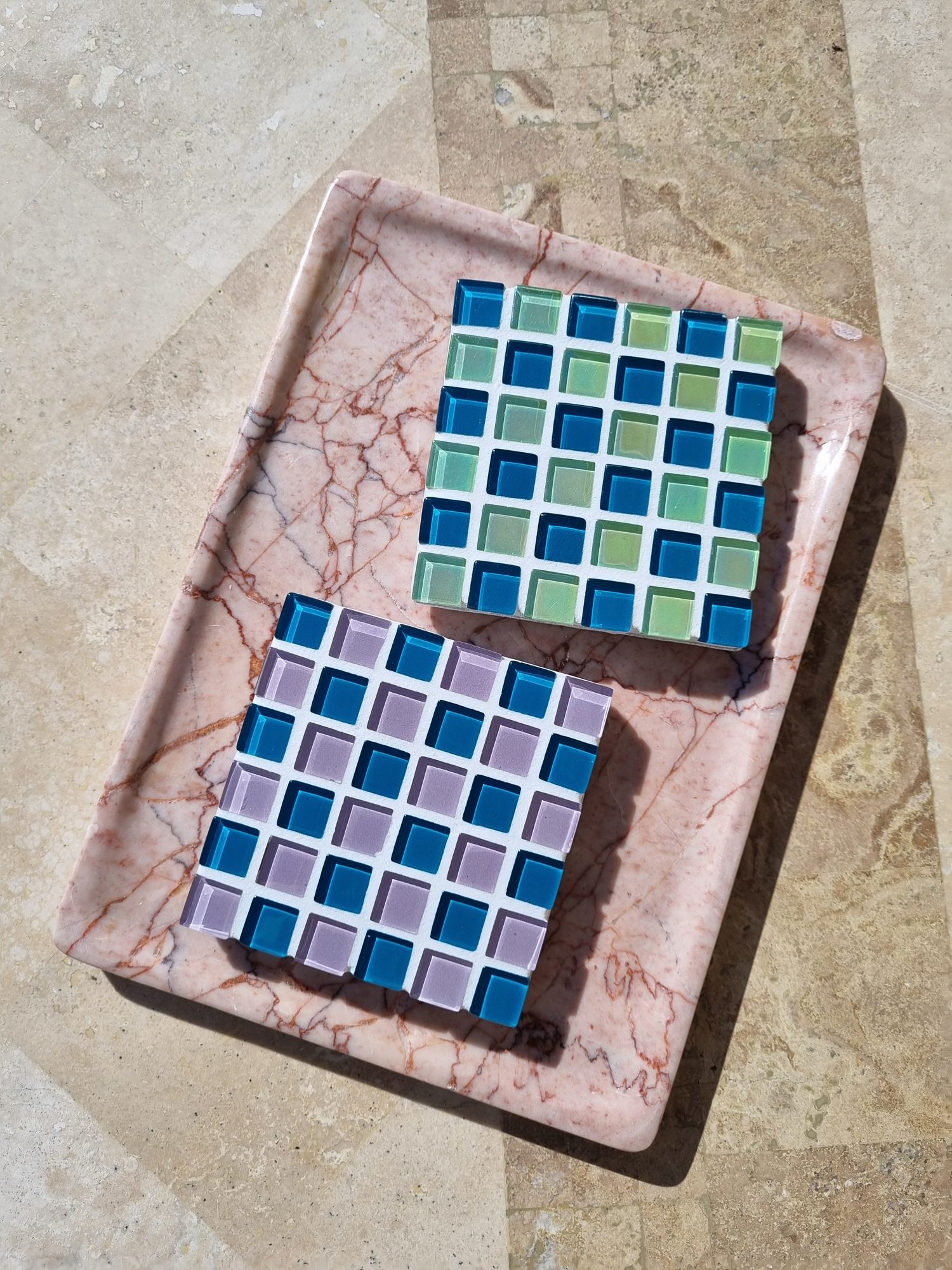 Pigeon Wing and Spanish Moss glass coasters on a pink marble tray